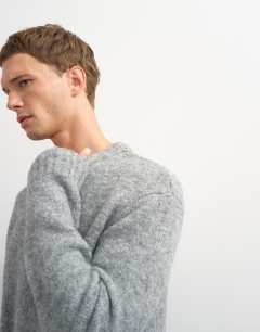 Model wearing Relaxed fit loose knit jumper in light grey