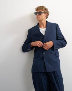 Model wearing Relaxed fit pinstripe double breasted blazer in navy