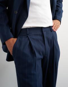 Model wearing Relaxed fit pinstripe trousers in navy