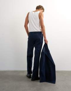 Model wearing Relaxed fit pinstripe trousers in navy