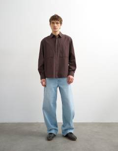 Model wearing Relaxed fit poplin shirt in brown