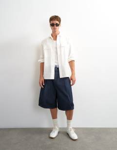 Model wearing Relaxed fit poplin utility shirt in ecru