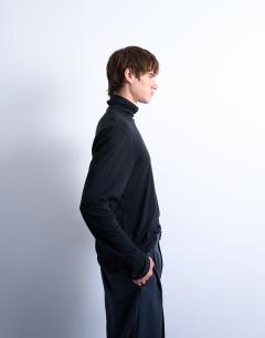 Model wearing Relaxed fit roll neck long sleeve t-shirt in black 