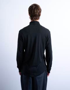 Model wearing Relaxed fit roll neck long sleeve t-shirt in black 