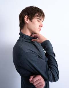 Model wearing Relaxed fit roll neck long sleeve t-shirt in dark grey 