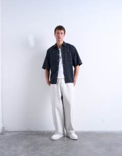 Model wearing Relaxed fit shirt with contrast stitch detail in black