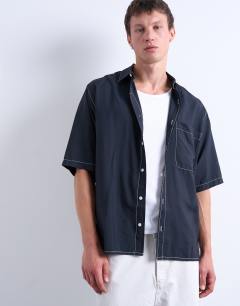 Model wearing Relaxed fit shirt with contrast stitch detail in black