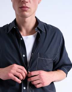 Model wearing Relaxed fit shirt with contrast stitch detail in black