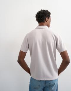 Model wearing Relaxed fit short sleeve revere pique polo in light grey