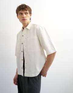 Model wearing Relaxed fit short sleeve twill crop overshirt in contrast ecru