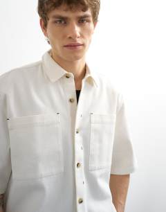 Model wearing Relaxed fit short sleeve twill crop overshirt in contrast ecru