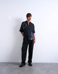Model wearing Relaxed fit short sleeve twill shirt with placement floral print in black