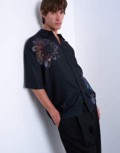 Model wearing Relaxed fit short sleeve twill shirt with placement floral print in black