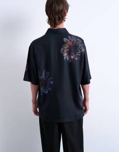 Model wearing Relaxed fit short sleeve twill shirt with placement floral print in black