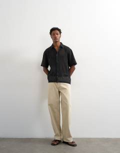 Model wearing Relaxed fit short sleeve woven mesh shirt in black