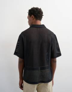 Model wearing Relaxed fit short sleeve woven mesh shirt in black
