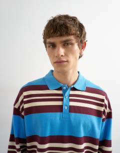 Model wearing Relaxed fit stripe polo in blue