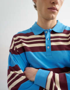 Model wearing Relaxed fit stripe polo in blue