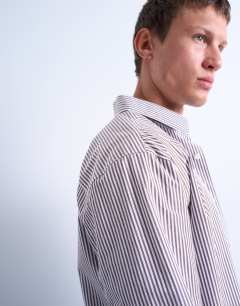Model wearing Relaxed fit stripe shirt in brown