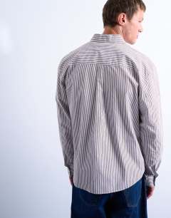 Model wearing Relaxed fit stripe shirt in brown