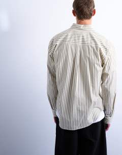 Model wearing Relaxed fit stripe shirt in dusty green