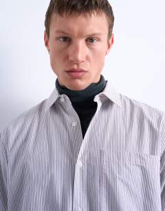 Model wearing Relaxed fit stripe shirt in tonal ecru & brown