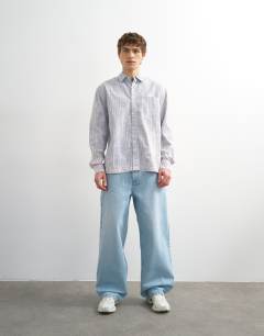 Model wearing Relaxed fit stripe shirt with acid wash in blue