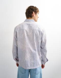 Model wearing Relaxed fit stripe shirt with acid wash in blue