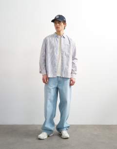 Model wearing Relaxed fit stripe shirt with acid wash in blue