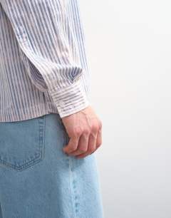Model wearing Relaxed fit stripe shirt with acid wash in blue