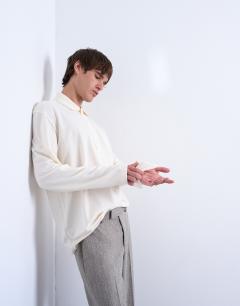 Model wearing Relaxed fit structured stitch long sleeve polo in ecru 