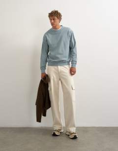 Model wearing Relaxed fit sweatshirt in washed blue