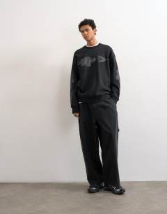 Model wearing Relaxed fit sweatshirt with digital floral front and back print in washed black