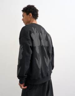Model wearing Relaxed fit sweatshirt with digital floral front and back print in washed black