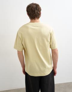 Model wearing Relaxed fit t-shirt with Amor embroidery in washed yellow