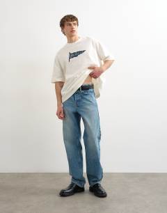 Model wearing Relaxed fit t-shirt with Bonjour Flag patch in ecru