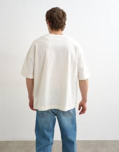 Model wearing Relaxed fit t-shirt with Bonjour Flag patch in ecru