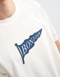 Model wearing Relaxed fit t-shirt with Bonjour Flag patch in ecru