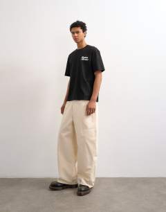 Model wearing Relaxed fit t-shirt with Bonjour print in black