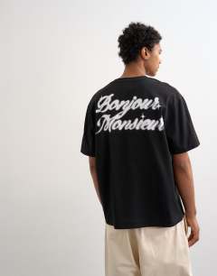 Model wearing Relaxed fit t-shirt with Bonjour print in black