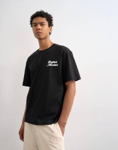 Model wearing Relaxed fit t-shirt with Bonjour print in black