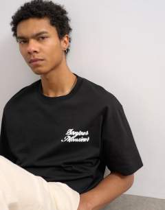 Model wearing Relaxed fit t-shirt with Bonjour print in black