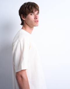 Model wearing Relaxed fit t-shirt with floral line drawing embroidery in ecru