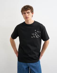 Model wearing Relaxed fit t-shirt with front and back bird print in black