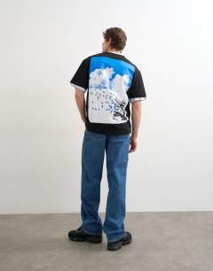 Model wearing Relaxed fit t-shirt with front and back bird print in black