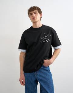 Model wearing Relaxed fit t-shirt with front and back bird print in black