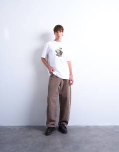 Model wearing Relaxed fit t-shirt with front and back collage floral print in white