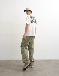 Model wearing Relaxed fit t-shirt with front and back forgiveness print in black