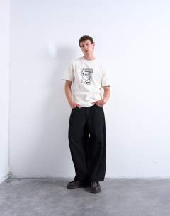 Model wearing Relaxed fit t-shirt with front and back Mothers Keeper print in ecru