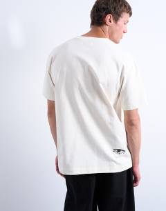 Model wearing Relaxed fit t-shirt with front and back Mothers Keeper print in ecru